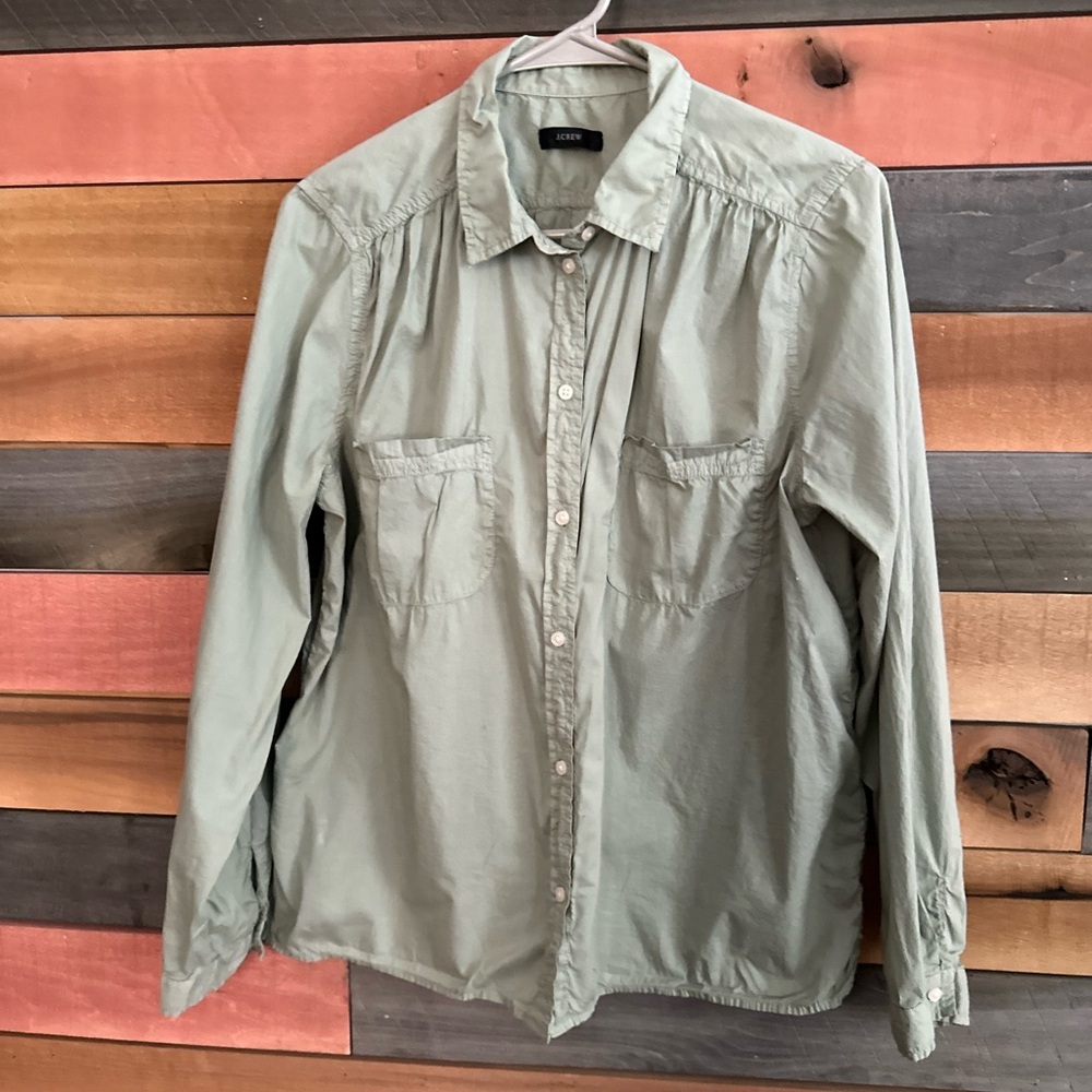 This is a J.Crew garment-dyed cotton poplin utility shirt in a light green color